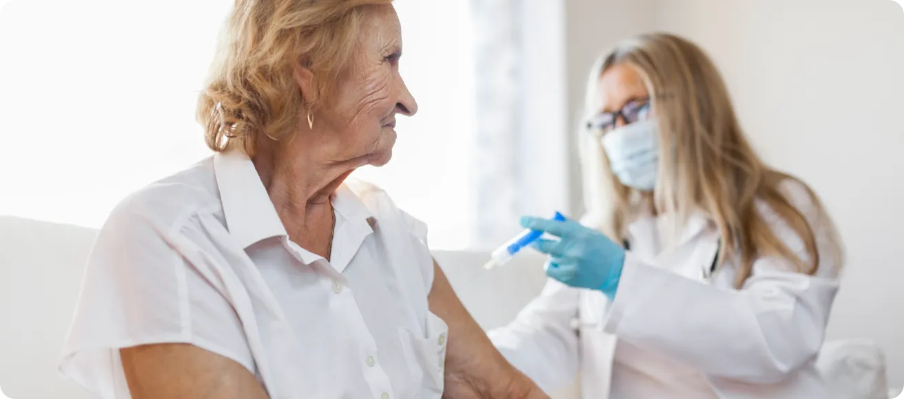 A nurse administering a vaccine to an elderly patient.