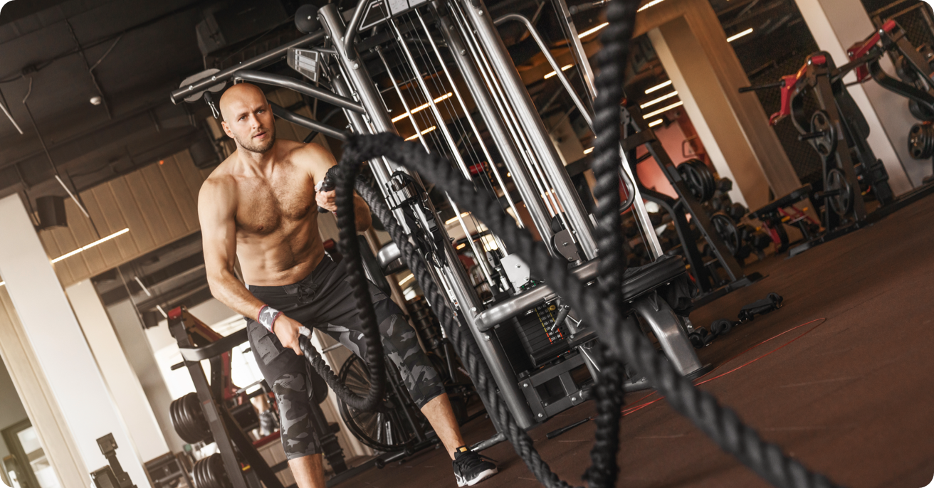 Person working out using ropes at a gym.
