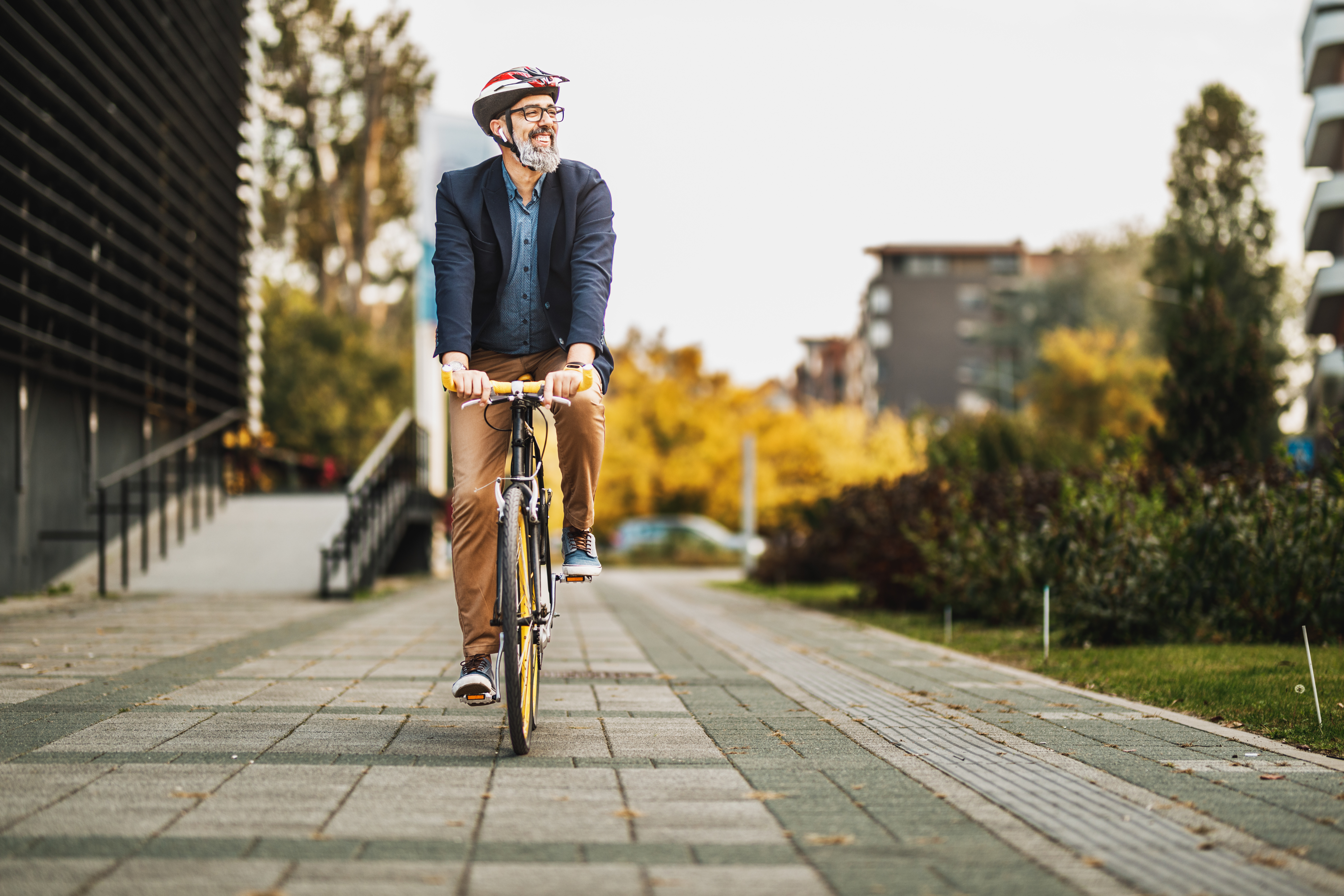 Man with a helmet riding a bicycle.