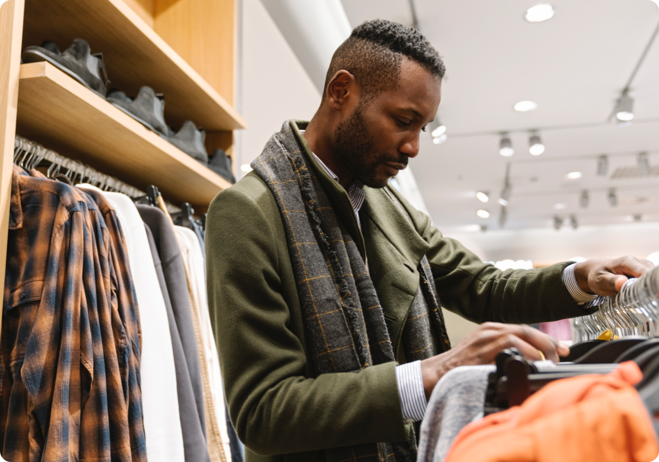 Young man shopping for clothing at a store.