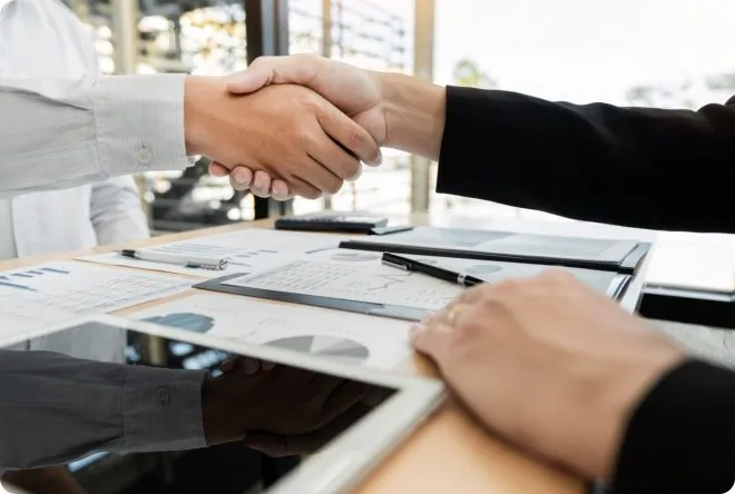 Two business people shaking hands.