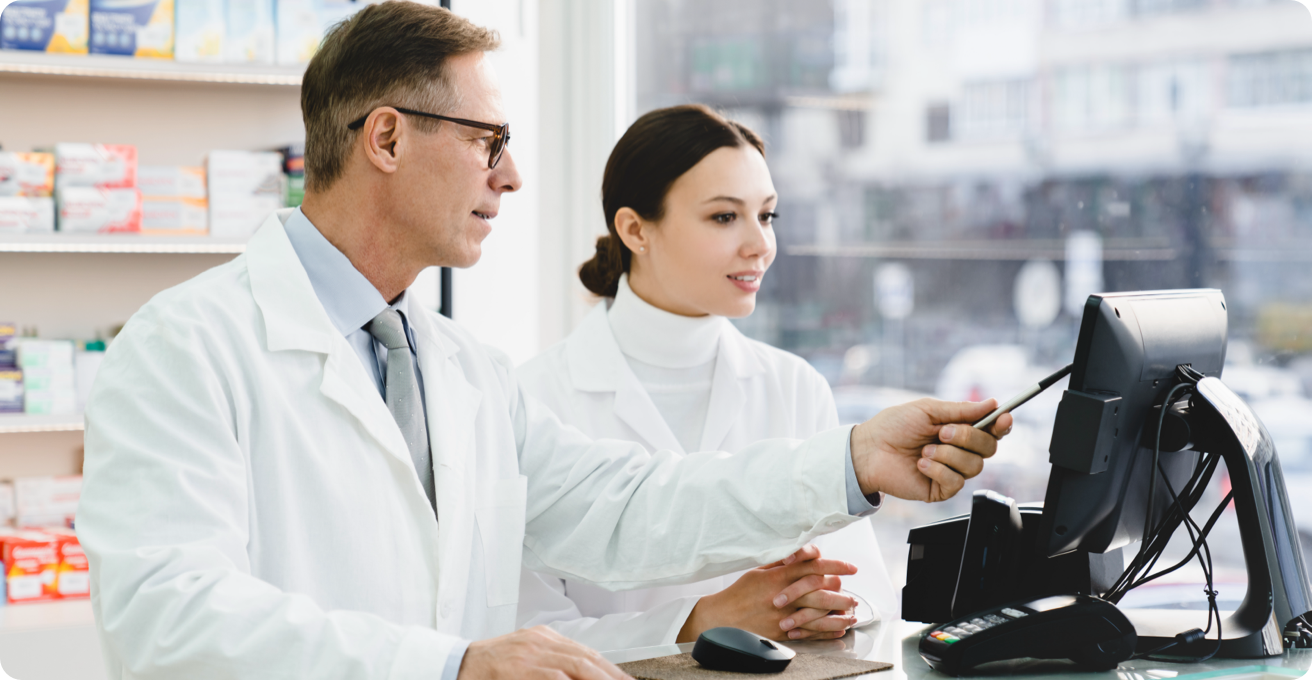 Two pharmacists looking at a computer screen.
