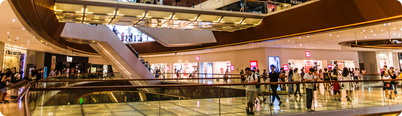 Landscape view of a shopping center filled with shoppers.