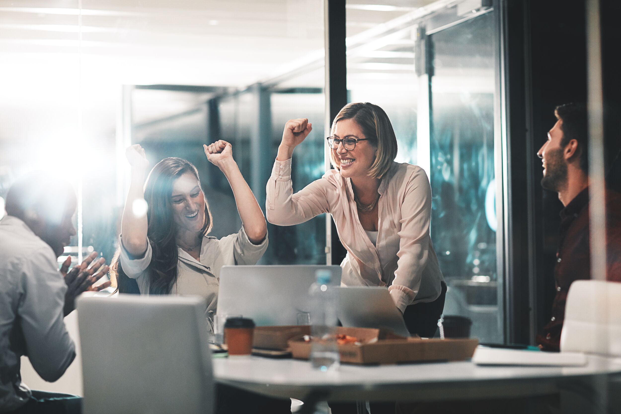 Female coworkers celebrating.